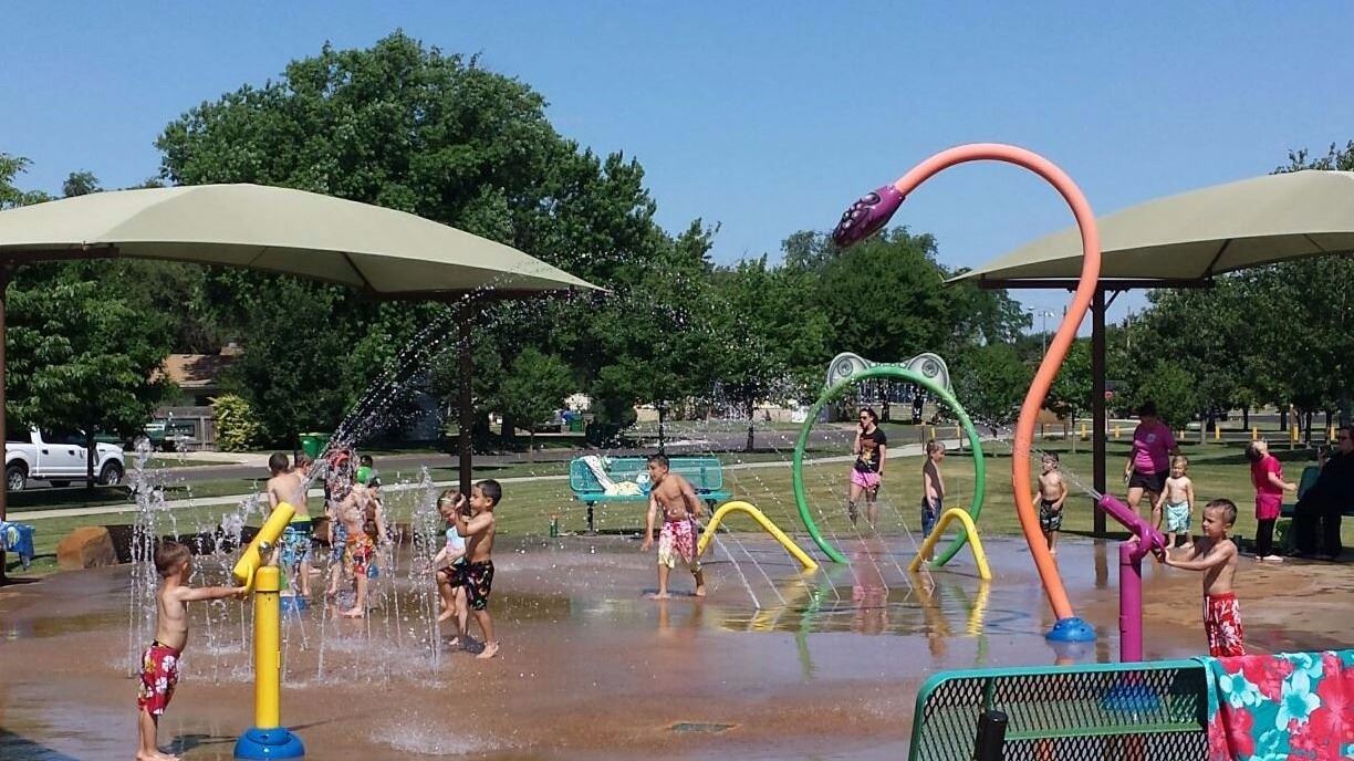 Children laughing and playing in a colorful water park